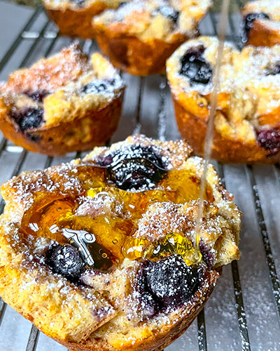 Indulge in the delightful Blueberry French Toast Muffins: golden-brown, fluffy muffins bursting with juicy blueberries, perfect for a breakfast treat or afternoon snack.